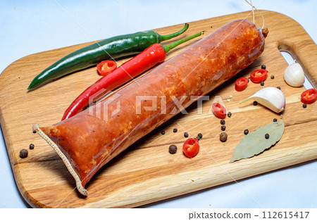 Tasty sausages and vegetables isolated over solid background Tasty sausages and vegetables isolated over solid background 112615417
