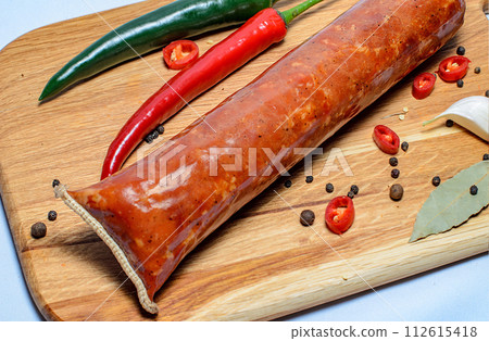 Tasty sausages and vegetables isolated over solid background Tasty sausages and vegetables isolated over solid background 112615418