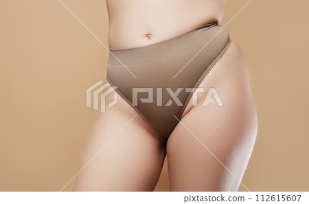 A woman's hand holds a fat cellulite and a stretch A woman's hand holds a fat cellulite and a stretch 112615607