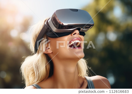 AI-generated content. Portrait of happy young woman using VR glasses of metaverse virtual reality. Outdoors. 112616683