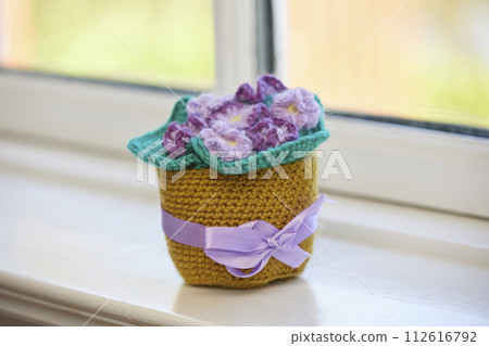 Knitted toys violet on the windowsill Knitted toys violet on the windowsill 112616792