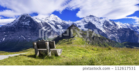 Swiss nature scenery. Scenic snowy Alps mountains Beauty in nature. Switzerland landscape. View of Mannlichen mountain and famous hiking route "Royal road". 112617531