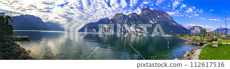 Italy travel ,scenic Garda lake , Trento province. Lago di Garda. Wonderful autumn scenery. sunny morning in Riva del Garda. Italy travel ,scenic Garda lake , Trento province. Lago di Garda. Wonderful autumn scenery. sunny morning in Riva del Garda. 112617536