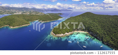 Sivota - stunning aerial drone video of turquoise sea known as Blue Lagoon and white sandy beaches. Epirus, Greece summer holidays. 112617555