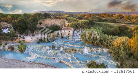Most famous natural thermal hot spings pools in Tuscany - scenic Terme di Mulino vecchio ( Thermals of Old Windmill) in Grosseto province. high angle drone view Most famous natural thermal hot spings pools in Tuscany - scenic Terme di Mulino vecchio ( Thermals of Old Windmill) in Grosseto province. high angle drone view 112617561