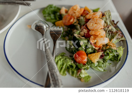 Fresh shrimp salad, vibrant greens, elegant setting 112618119
