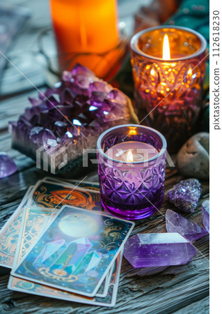 Crystals, candles and other divination tools next to the tarot cards. Generative AI 112618230