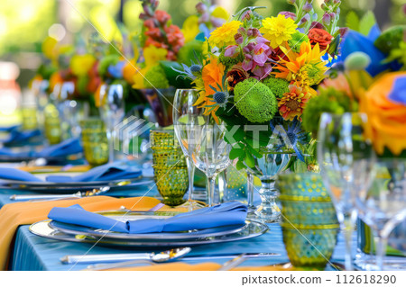 Table setting with bright colored floral centerpieces. Generative AI 112618290