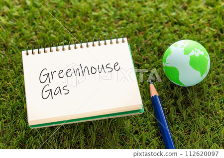 There is a notebook with the word greenhouse gas and Earthball. It's an eye-catching image. There is a notebook with the word greenhouse gas and Earthball. It's an eye-catching image. 112620097
