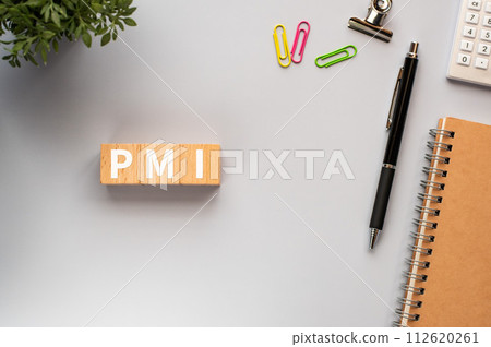 There is a wood cube with the word PMI on it. It stands for post-merger integration as an eye-catching image. 112620261