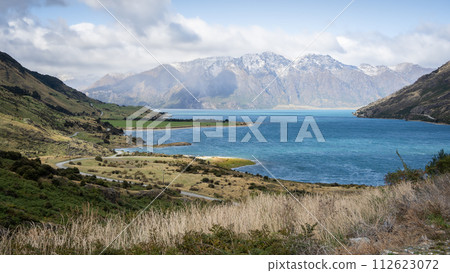 Beautiful landscape with glacier lake surrounded by green fields and high mountains, New Zealand 112623072