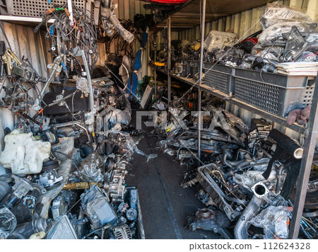 freight container filled with used car parts on junkyard shop 112624328