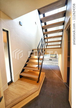 Stairs with sunlight shining through the skylight Stairs with sunlight shining through the skylight 112624356
