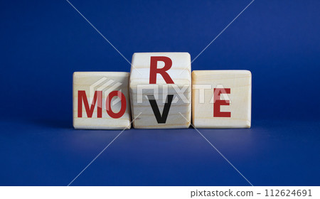 More Move symbol. Wooden cubes with words More Move. Beautiful deep blue background. Business concept and More Move. Copy space 112624691