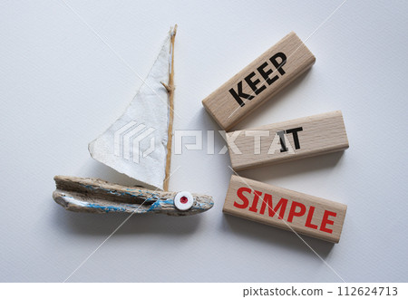 Keep it Simple symbol. Concept words Keep it Simple on wooden blocks. Beautiful white background with boat. Business and Keep it Simple concept. Copy space. 112624713