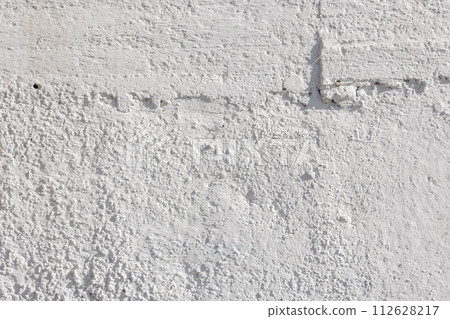 rough whitewash or white plaster wall under direct sunlight, full-frame background and texture rough whitewash or white plaster wall under direct sunlight, full-frame background and texture 112628217