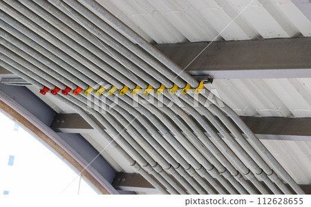 Steel Tube Fitting, Electricity and signal wire tubes attached on wall and ceiling, loft design or concept. Tube for fa, nps, cctv, ltg, pds, tel, cas Steel Tube Fitting, Electricity and signal wire tubes attached on wall and ceiling, loft design or concept. Tube for fa, nps, cctv, ltg, pds, tel, cas 112628655