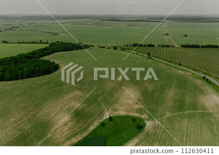 Aerial top view summer day aerial green nature Ukraine. Grass field blue sky white clouds Aerial top view summer day aerial green nature Ukraine. Grass field blue sky white clouds 112630411
