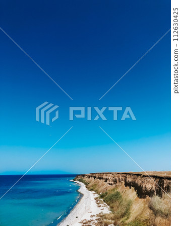 cliff sea blue aquamarine waves line sunny beach. Soft wave of ocean foam. cliff sea blue aquamarine waves line sunny beach. Soft wave of ocean foam. 112630425