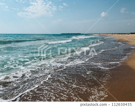 Sea blue aquamarine waves line sunny sand beach. Soft wave of ocean foam. 112630435