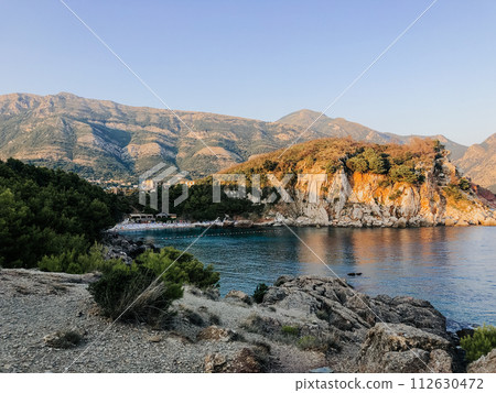 Top view Montenegro Sutomore stones beach blue turquoise Adriatic sea water mountains on sunset. 112630472