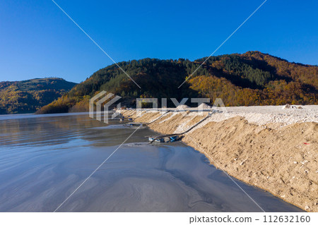 Aerial view of mining residual waters from a copper mine discharging into decanting pond. Geamana, Romania Aerial view of mining residual waters from a copper mine discharging into decanting pond. Geamana, Romania 112632160
