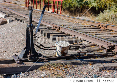 manual railroad switch with lever and counterweight at summer day 112633688