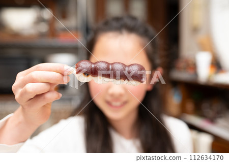 child eating skewered dumplings 112634170