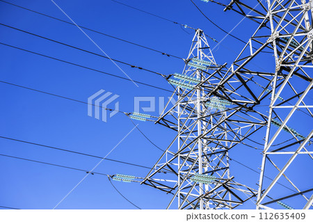 High voltage tower against the sky. Power transmission tower with wires High voltage tower against the sky. Power transmission tower with wires 112635409