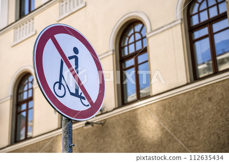 Scooter ban. Sign prohibiting movement on a scooter on a city street Scooter ban. Sign prohibiting movement on a scooter on a city street 112635434