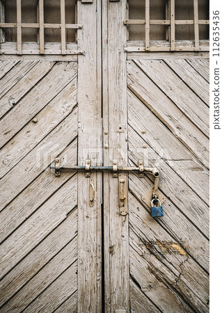 Old barn gate. Wooden rustic gate for a warehouse, stable or barn 112635436