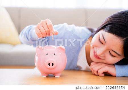 A woman saving money A woman saving money 112636654