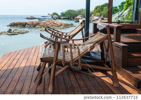 Wooden sunbed at resort patio by sea, Ko Man Klang, Rayong 112637718
