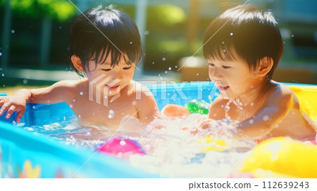 A child playing in the pool, a cheerful summer Japanese boy A child playing in the pool, a cheerful summer Japanese boy 112639243