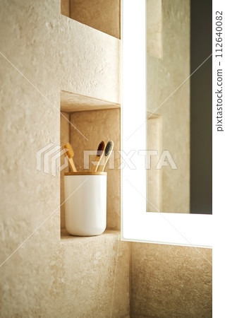 Natural bamboo toothbrushes in a glass in the bathroom. Natural bamboo toothbrushes in a glass in the bathroom. 112640082