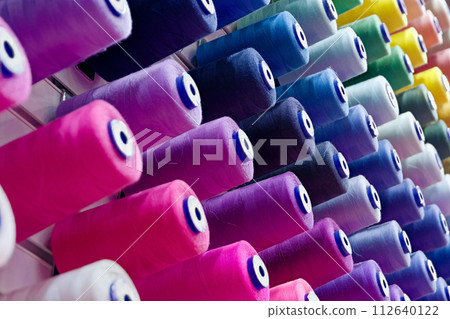 Assorted spools of multi-coloured cotton threads 112640122