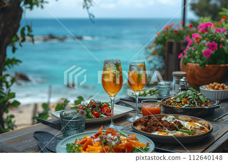 Illustration of delicious looking food beautifully arranged on a beach by the sea. Can be used to attract tourists, promote seaside restaurants, food products, catering services or travel packages 112640148