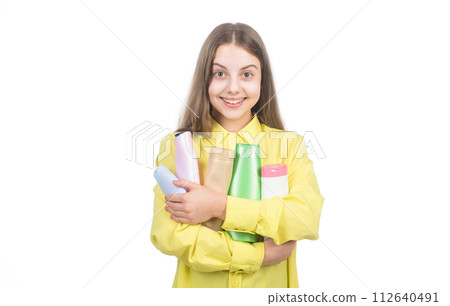 happy kid presenting shampoo or hair body conditioner bottle isolated on white, trichologist 112640491