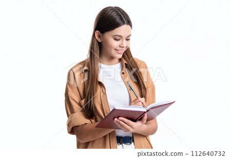 photo of cheerful teen girl noting school diary. teen girl noting school diary isolated on white 112640732
