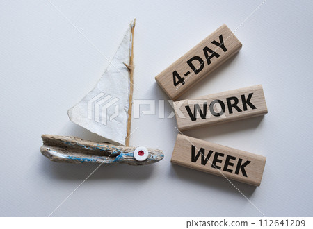 4-day work week symbol. Concept words 4-day work week on wooden blocks. Beautiful white background with boat. Business and 4-day work week concept. Copy space 4-day work week symbol. Concept words 4-day work week on wooden blocks. Beautiful white background with boat. Business and 4-day work week concept. Copy space 112641209