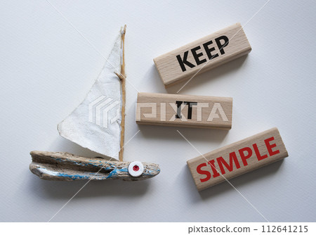 Keep it Simple symbol. Concept words Keep it Simple on wooden blocks. Beautiful white background with boat. Business and Keep it Simple concept. Copy space. 112641215
