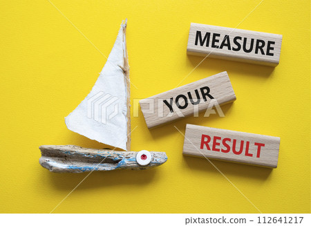 Measure your Result symbol. Concept words Measure your Result on wooden blocks. Beautiful yellow background with boat. Business and Measure your Result concept. Copy space. Measure your Result symbol. Concept words Measure your Result on wooden blocks. Beautiful yellow background with boat. Business and Measure your Result concept. Copy space. 112641217