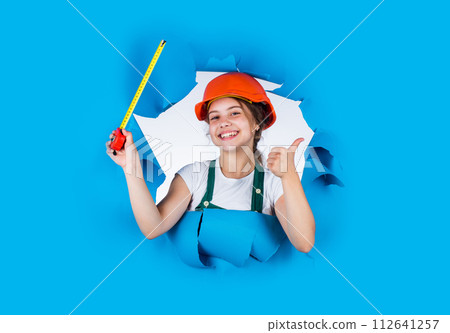 Real professional. growing concept. little girl with measuring tape. instruments for renovation apartment. childhood happiness and development. measuring the height. architect. playing with tools 112641257
