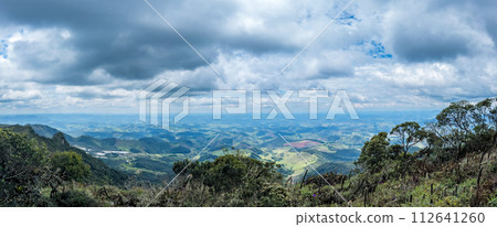 Expansive View of Lush Green Mountains Under Cloudy Sky Expansive View of Lush Green Mountains Under Cloudy Sky 112641260