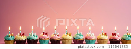 AI-generated content. Colorful cupcakes with lit candles are displayed against a pink background, indicating an indoor celebration event marking of joy and celebrating. with free space AI-generated content. Colorful cupcakes with lit candles are displayed against a pink background, indicating an indoor celebration event marking of joy and celebrating. with free space 112641883