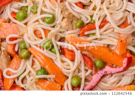 Delicious rice noodles or udon with chicken, carrots, pepper, salt, spices and herbs Delicious rice noodles or udon with chicken, carrots, pepper, salt, spices and herbs 112642548