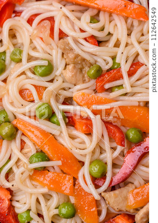 Delicious rice noodles or udon with chicken, carrots, pepper, salt, spices and herbs Delicious rice noodles or udon with chicken, carrots, pepper, salt, spices and herbs 112642549