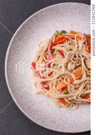 Delicious rice noodles or udon with chicken, carrots, pepper, salt, spices and herbs Delicious rice noodles or udon with chicken, carrots, pepper, salt, spices and herbs 112642569