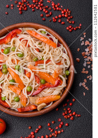 Delicious rice noodles or udon with chicken, carrots, pepper, salt, spices and herbs Delicious rice noodles or udon with chicken, carrots, pepper, salt, spices and herbs 112642581