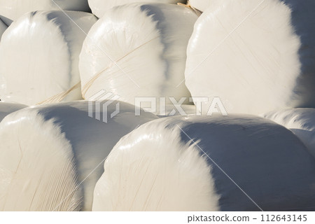 Bale of hay wrapped in plastic foil Bale of hay wrapped in plastic foil 112643145